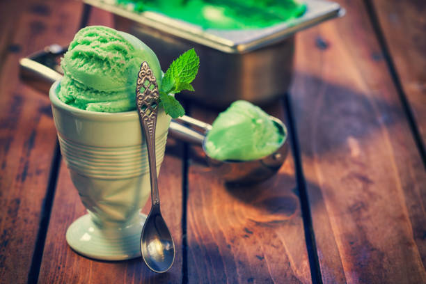 pistachio or mojito ice cream with mint served in a bowl on the old wooden background