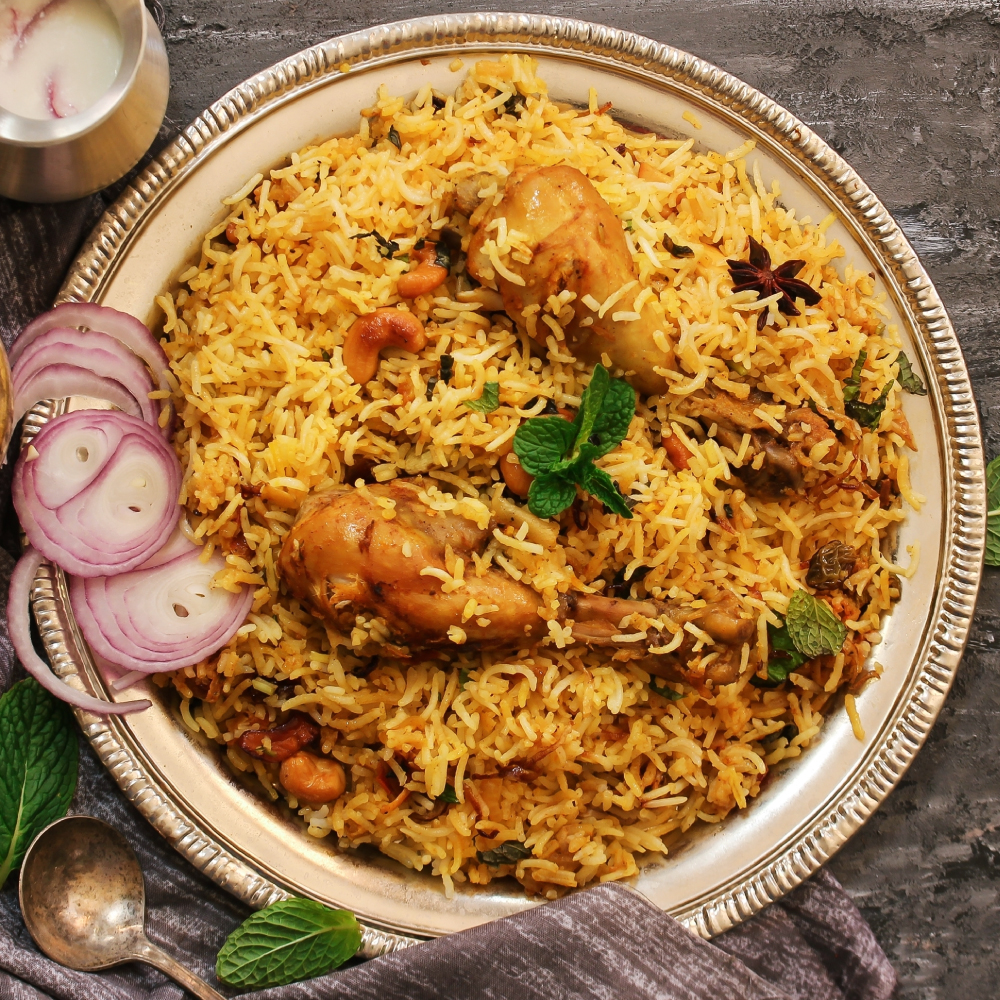 Hyderabadi Biriyani made with meat marinated and placed between layers of basmati rice flavored with saffron 