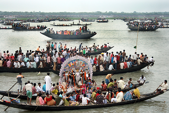 people are immersing of the idols of Maa Durga in ichhamoti river.
