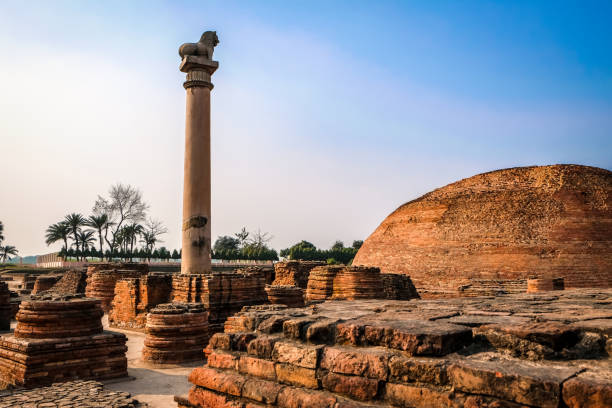 
Pillars of Ashoka with blue sky at Vaishali in Bihar, India. Beautiful scenic view of monument ancient with lion pole top in summer day