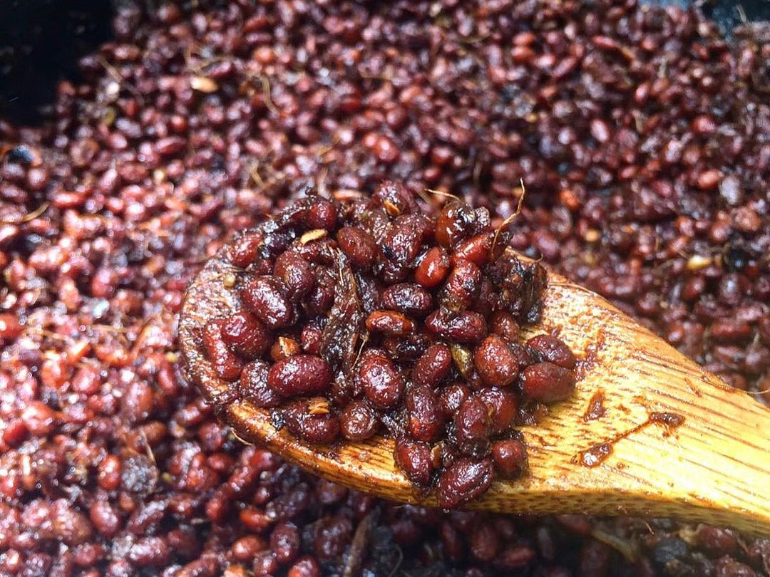 Axone preparation in Nagaland – Fermented soybean wrapped in banana leaves, a traditional Naga delicacy known for its strong aroma and umami flavor.